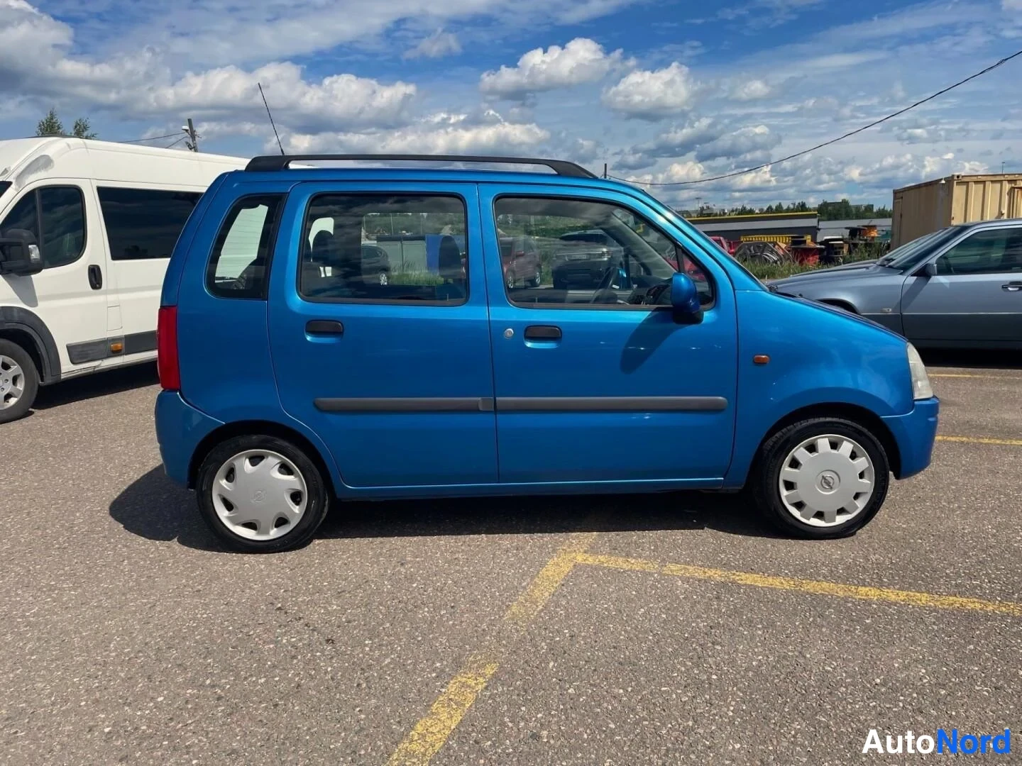 Blå Opel Agila 2001, från sidan, bild 8