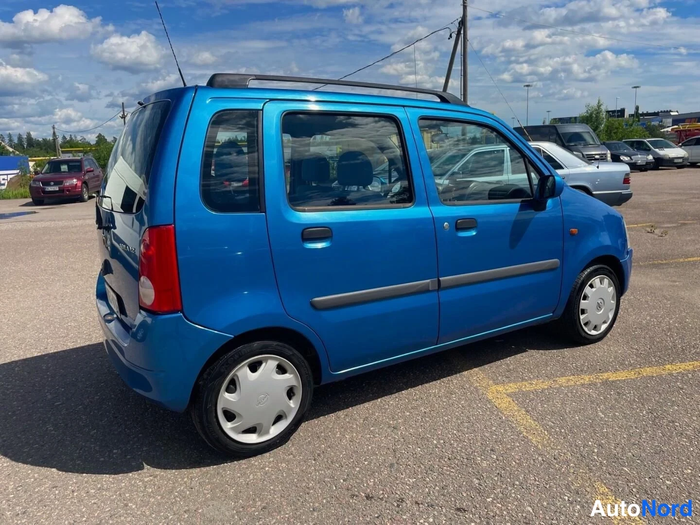 Blå Opel Agila 2001, snett bakifrån, bild 9