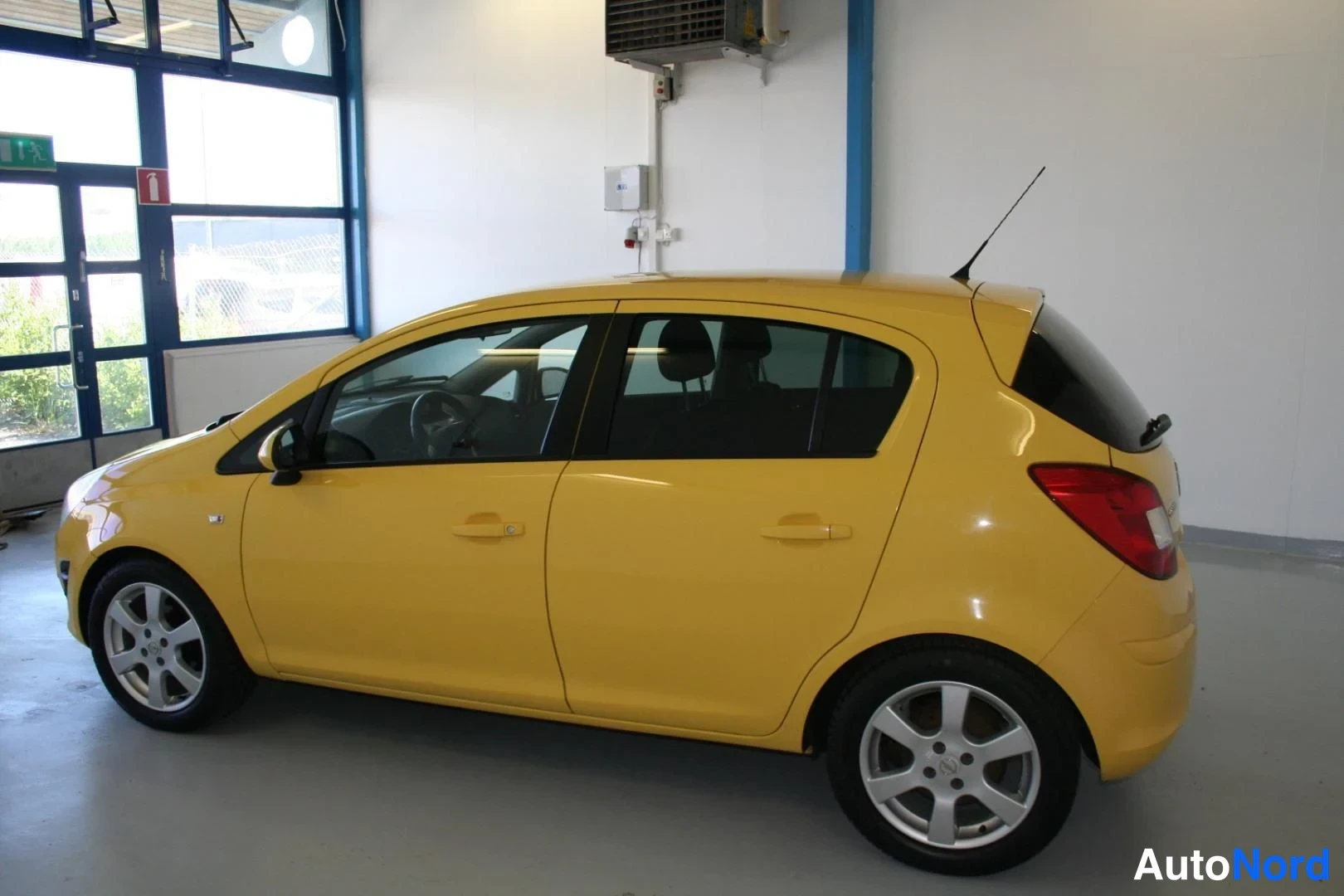 Gul Opel Corsa 2011, snett bakifrån, bild 4