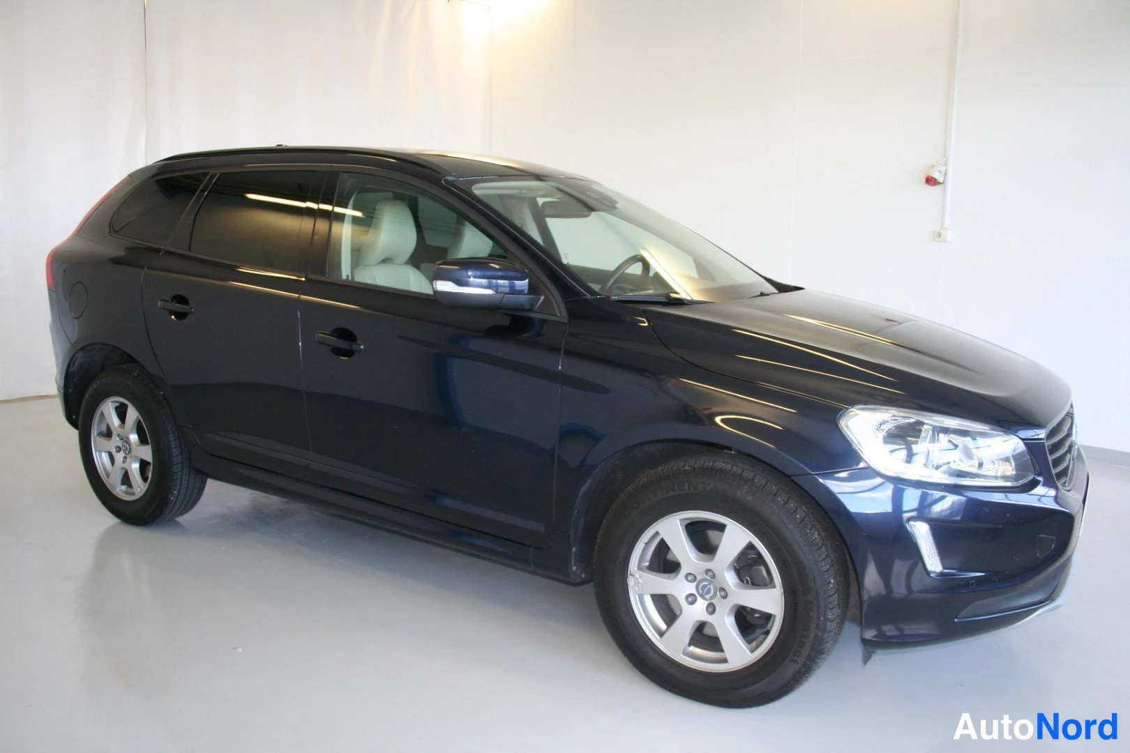 Blå Volvo XC60 2016, snett framifrån, fronten åt höger, bild 2