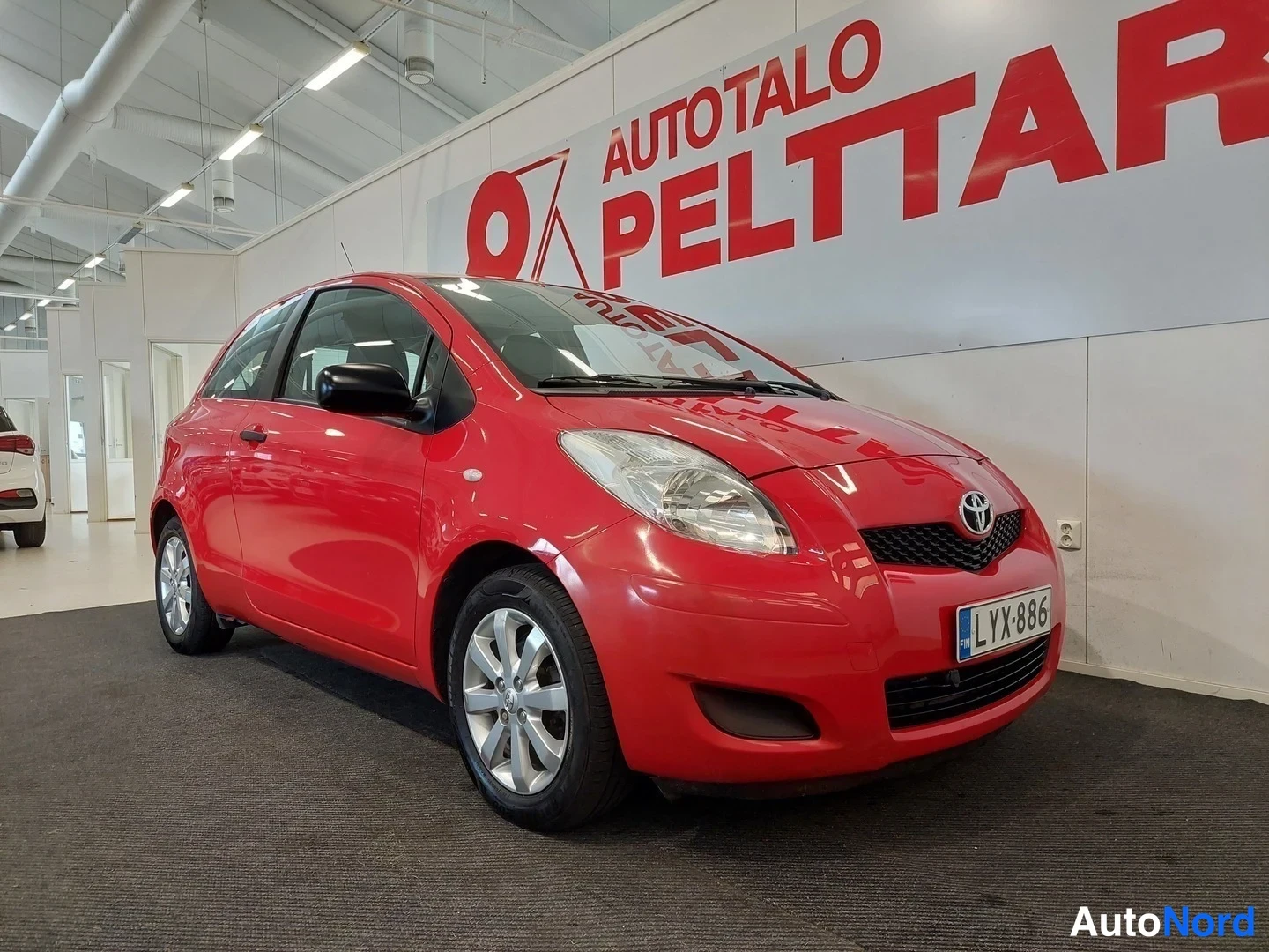 Punainen Toyota Yaris 2010, etuviisto, keula oikealle, kuva 2
