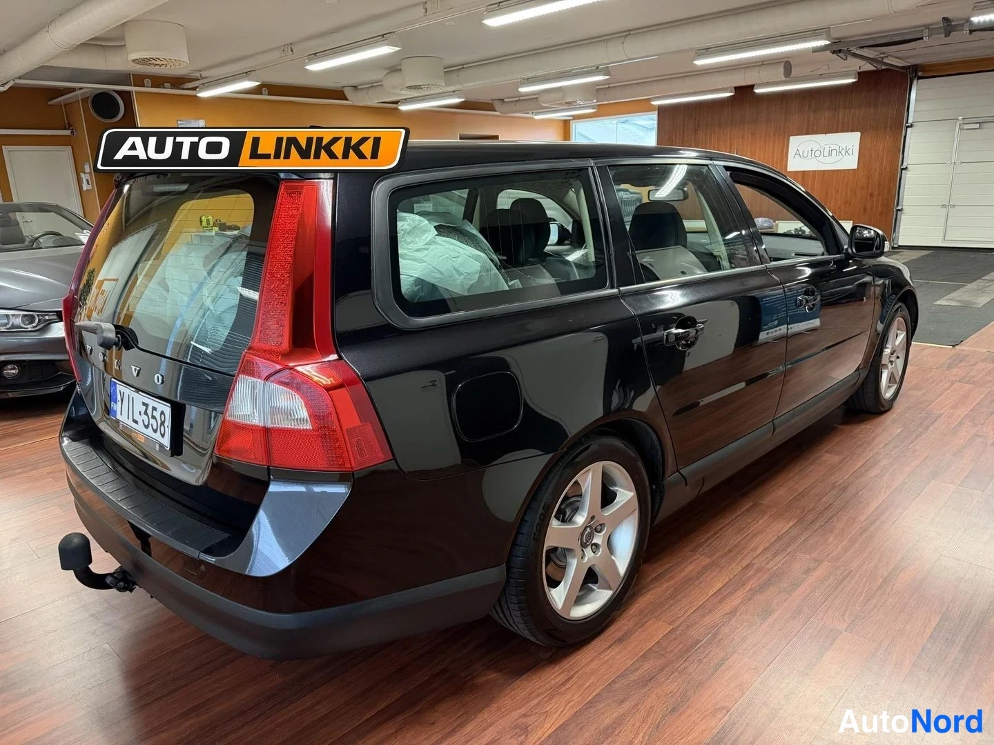 Svart Volvo V70 2008, snett bakifrån, bild 7