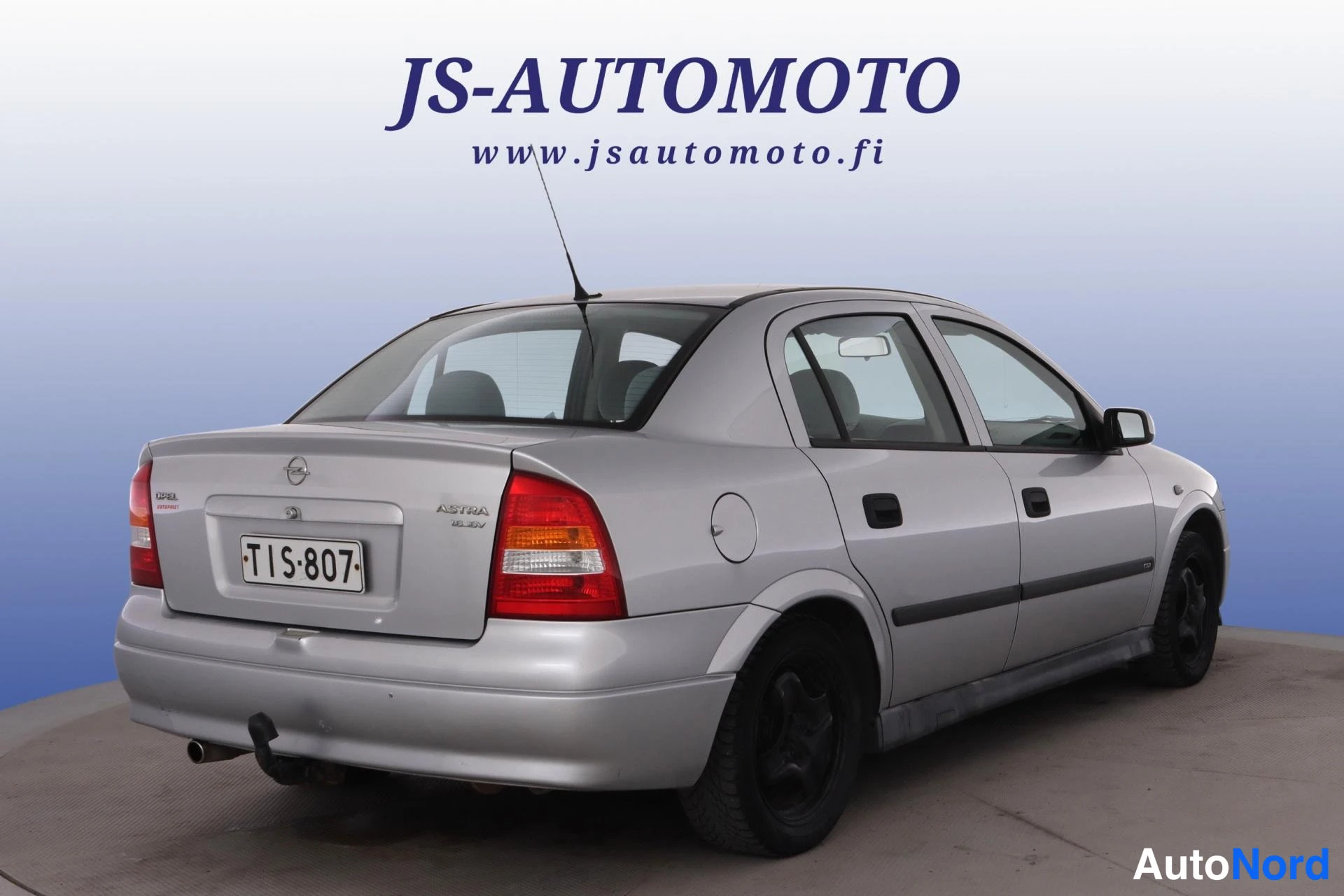 Grå Opel Astra 1998, snett bakifrån, bild 5