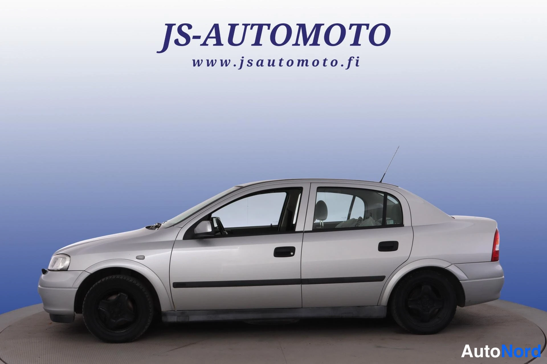 Grå Opel Astra 1998, från sidan, bild 4