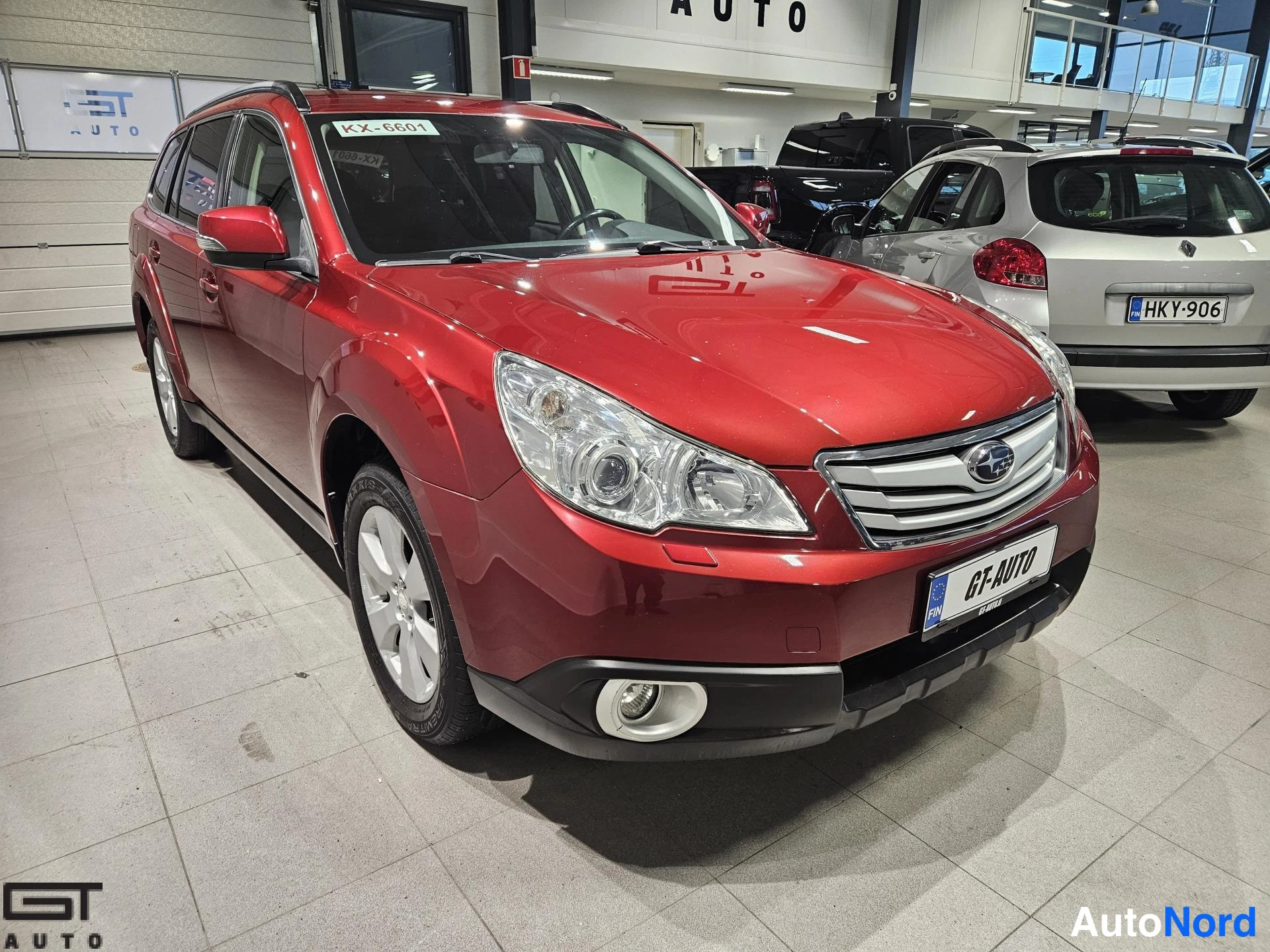 Red Subaru Outback 2013, front three-quarter, nose to the right, photo 3