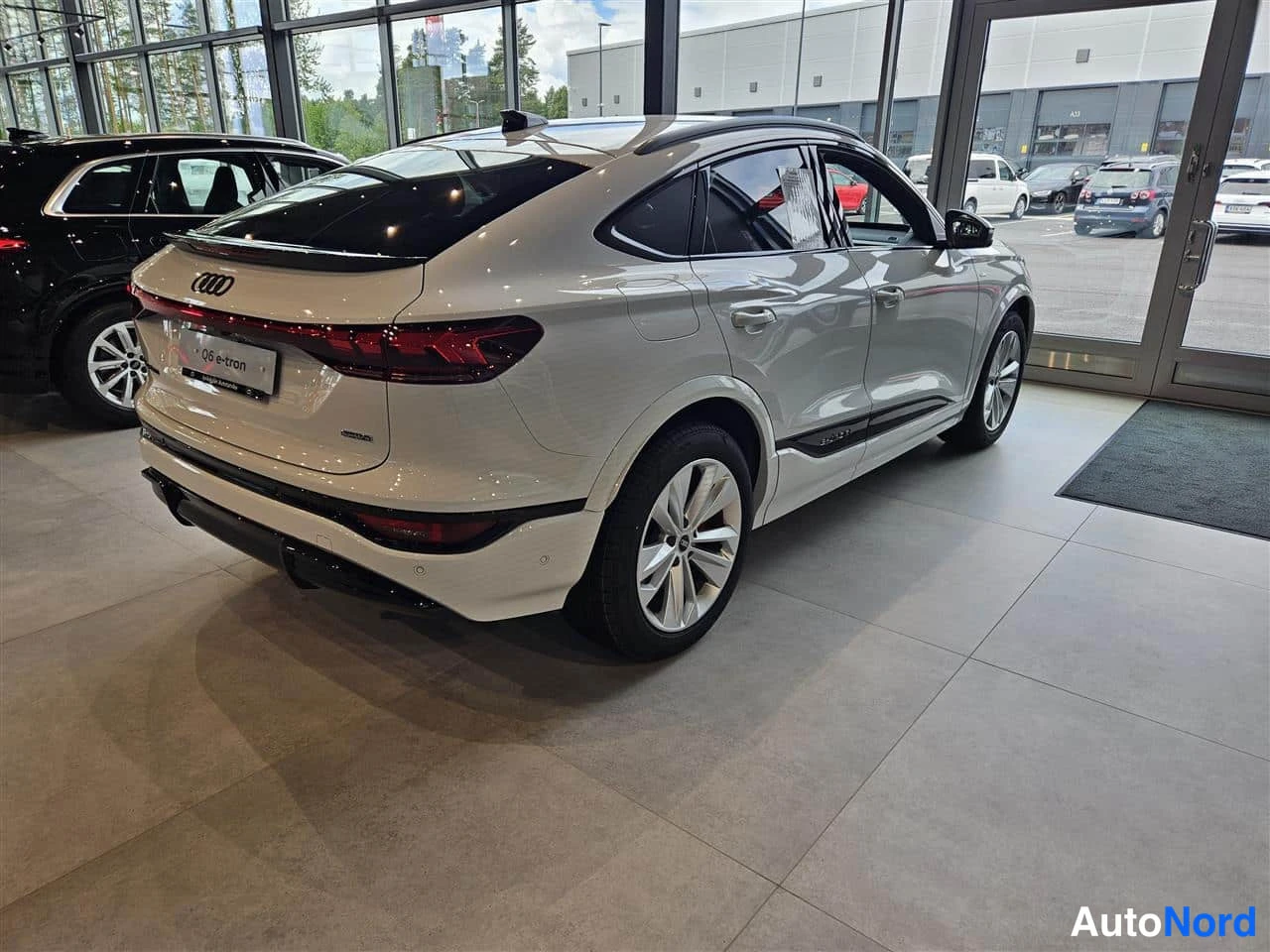 White Audi Q6 e-tron 2026, rear three-quarter, photo 8