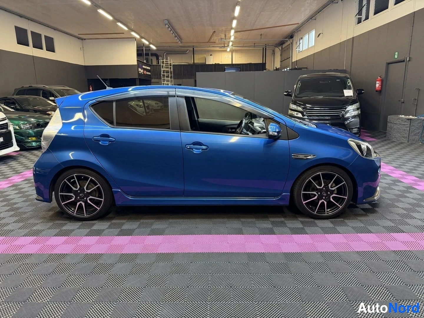 Blå Toyota Aqua 2014, snett framifrån, fronten åt höger, bild 2