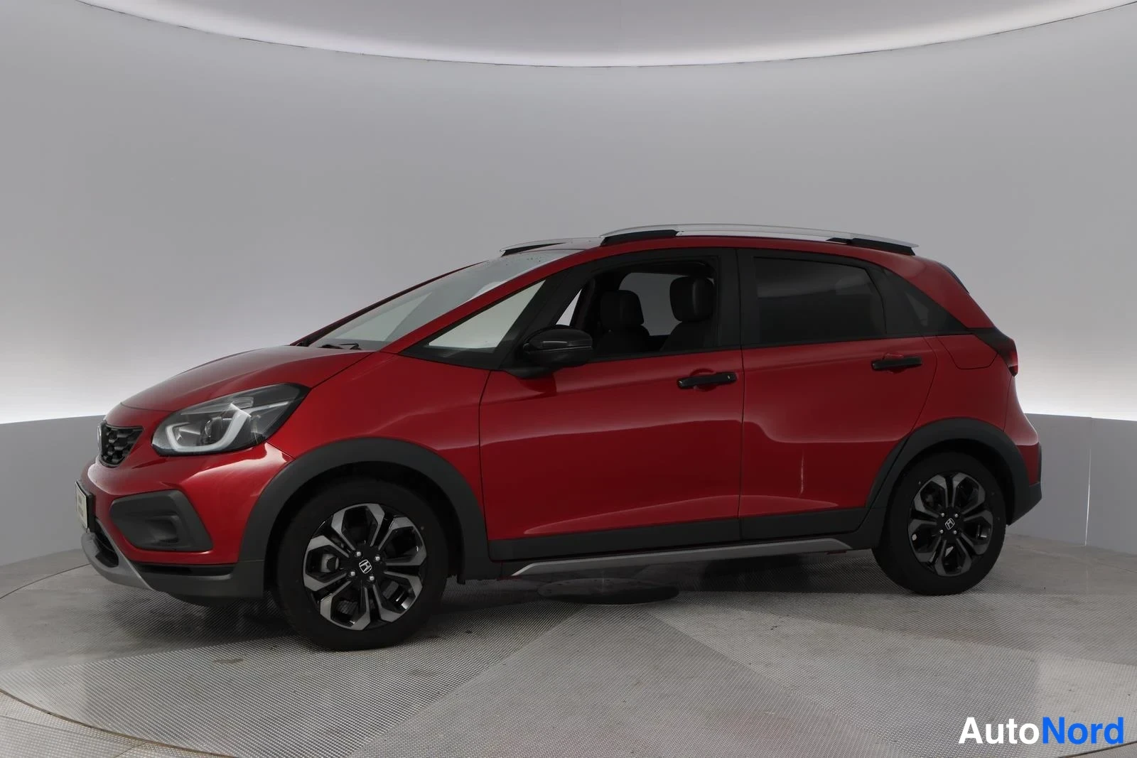 Red Honda Jazz 2025, front three-quarter, nose to the left, photo 2