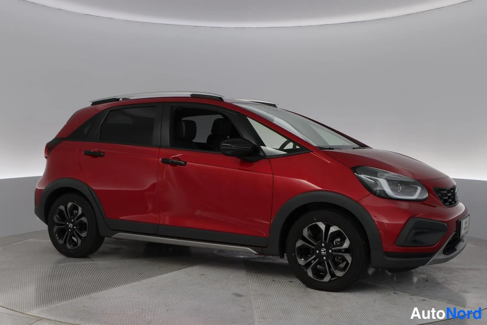 Red Honda Jazz 2025, front three-quarter, nose to the right, photo 3