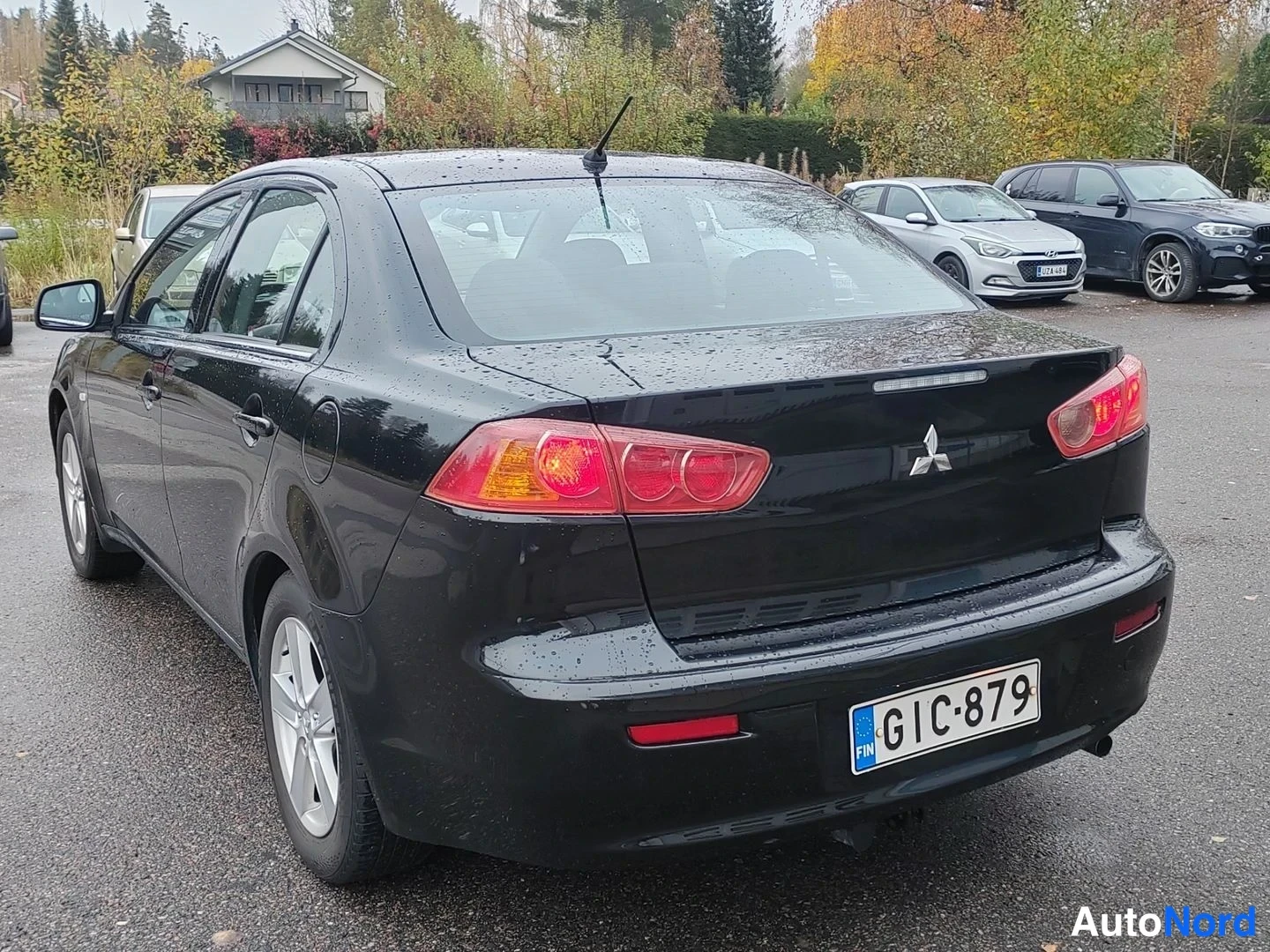 Svart Mitsubishi Lancer 2008, snett bakifrån, bild 6